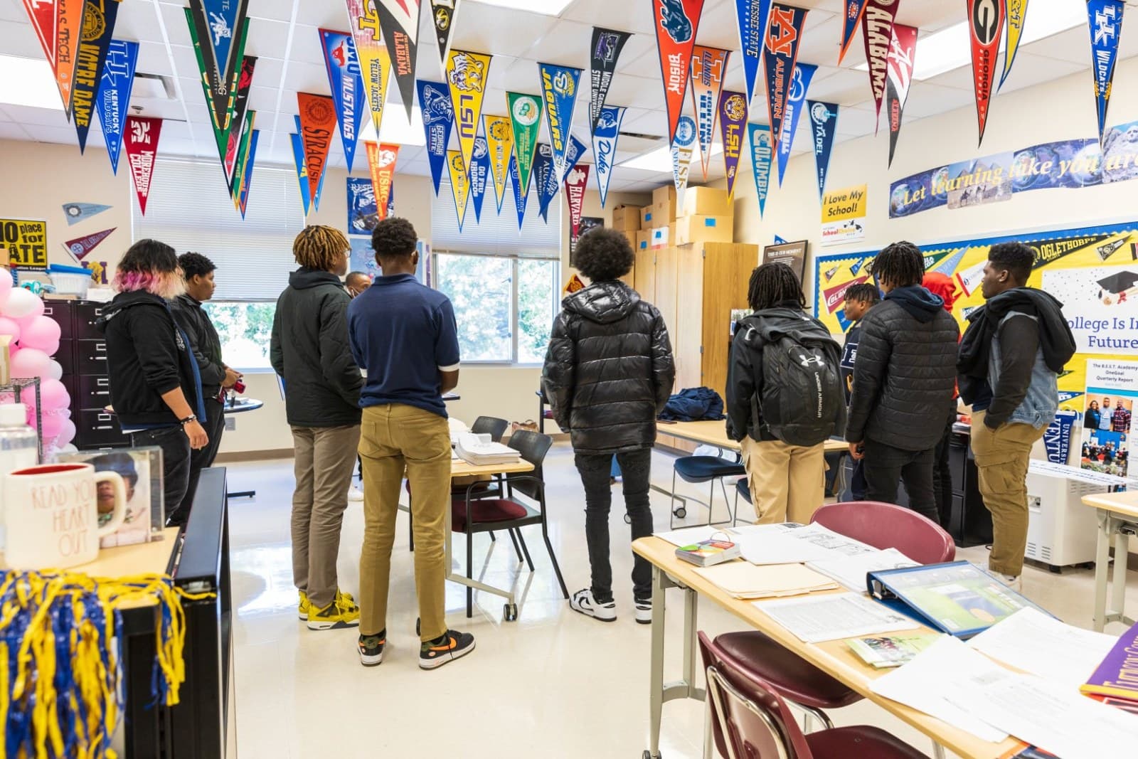 iMPACT Partners — mentors seated with high-school students at library tables during a session